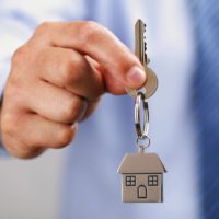 holding house key holding house key